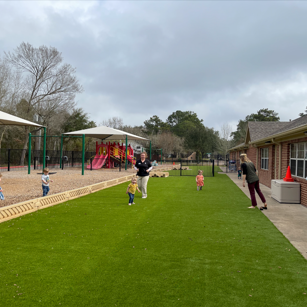 You can count on the quality installation of artificial turf from Sermons Turf Installs. Children playing on artificial turf at a daycare playground, showcasing a safe and low-maintenance surface.