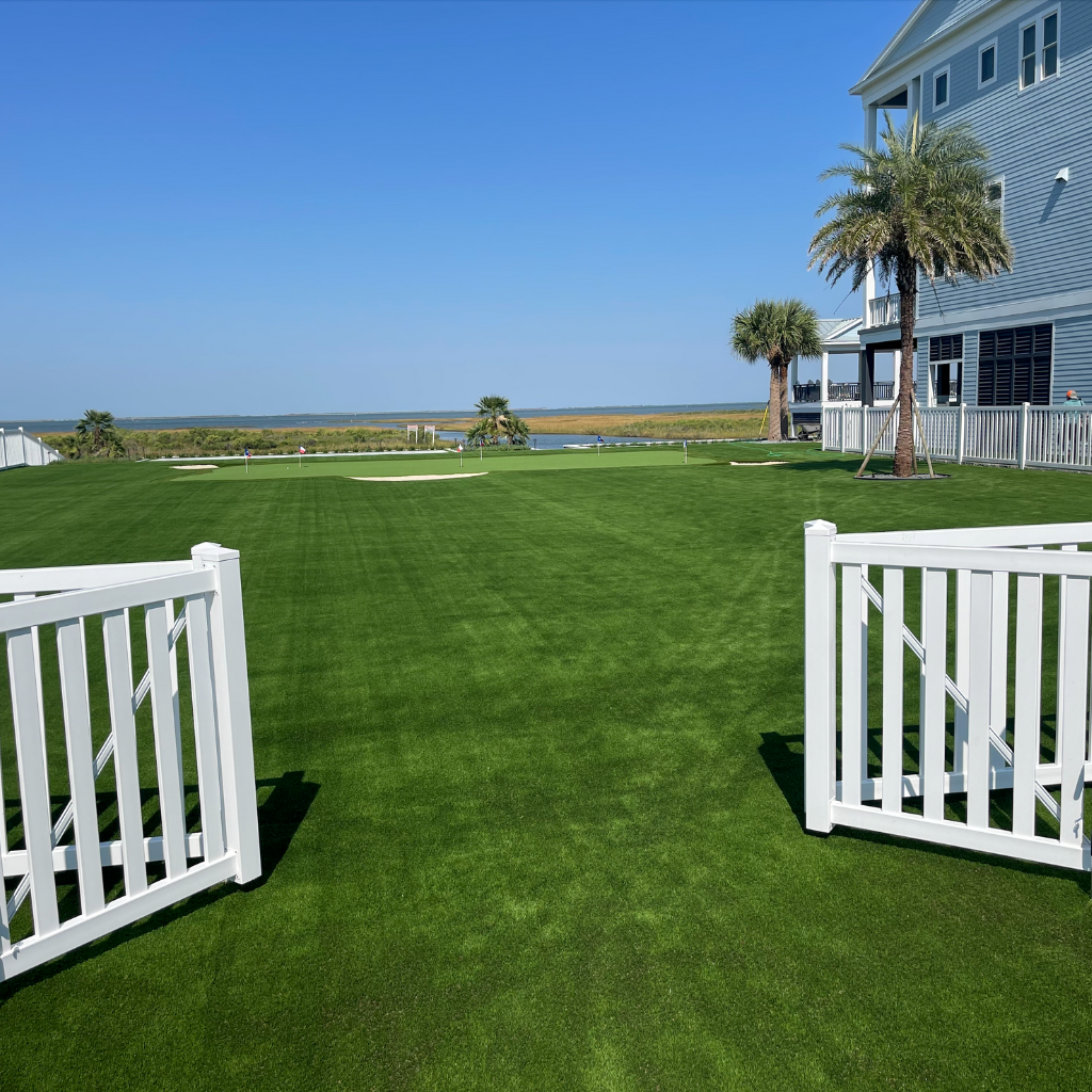 Private gated backyard with an expansive lawn and putting green near Galveston Bay, completed by Sermons Turf Installs.