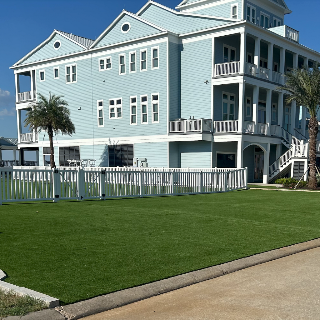 Front lawn with artificial turf installation near Galveston Bay, showcasing luxury turf by Sermons Turf Installs.