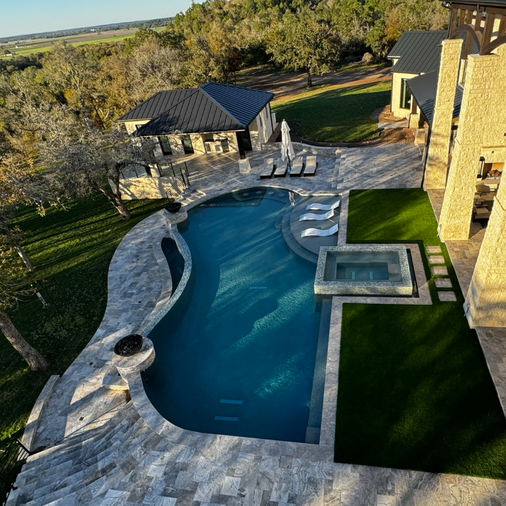Luxury artificial turf installations South Houston include this aerial view of a luxury pool with custom artificial turf installation by Sermons Turf Installs.